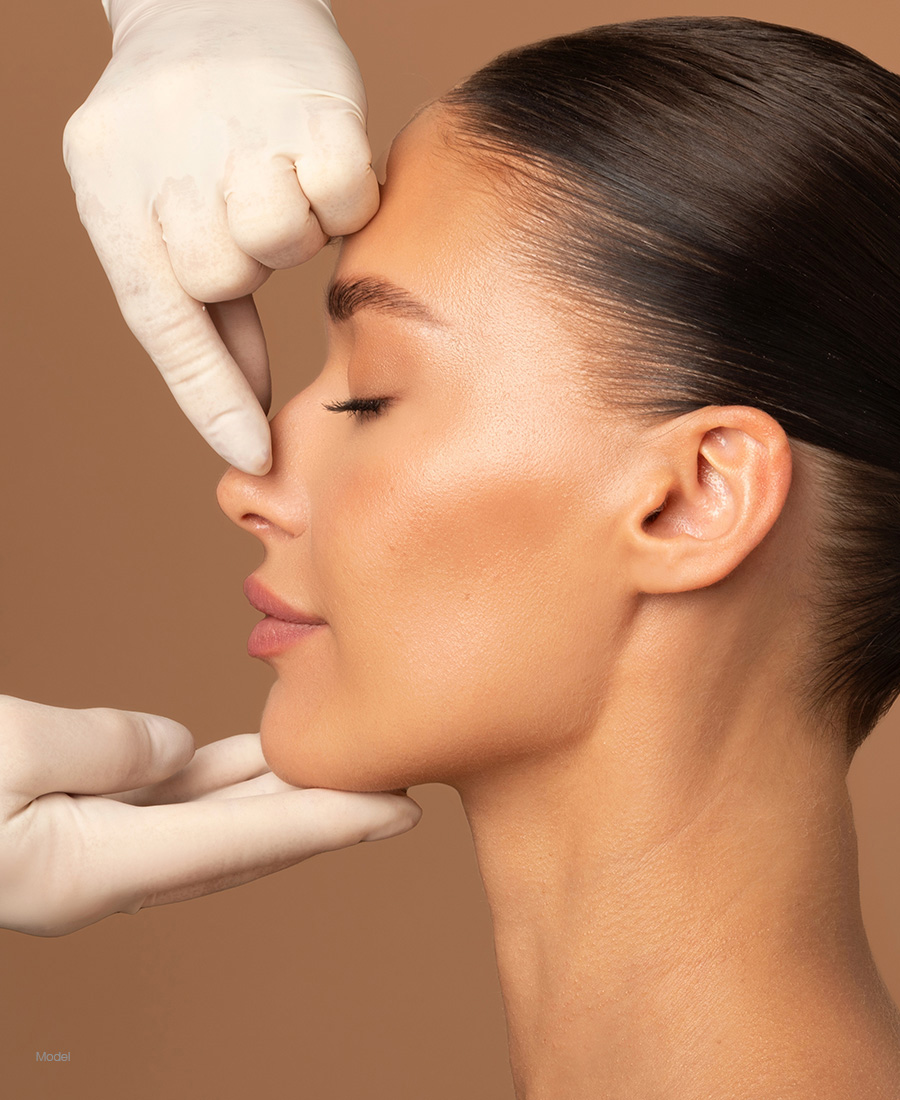 Woman having her nose examined